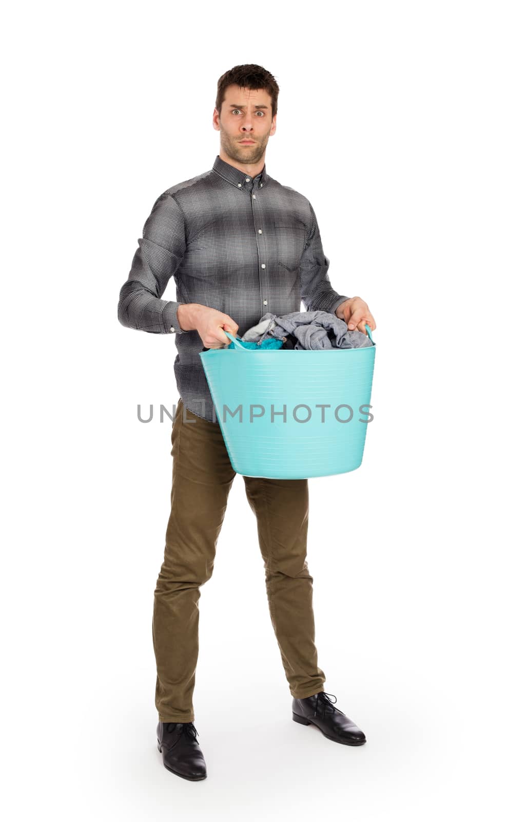 Full length portrait of a young man holding a laundry basket isolated on white background