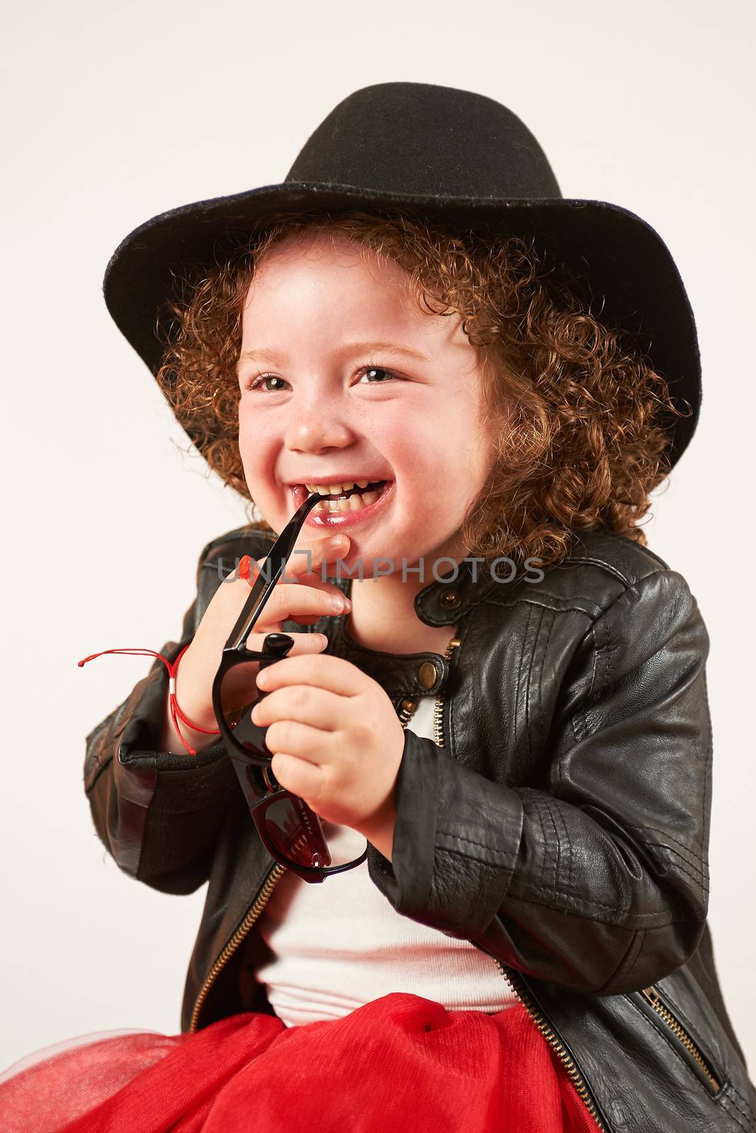Little Girl Fashion Model With Black Hat by Multipedia