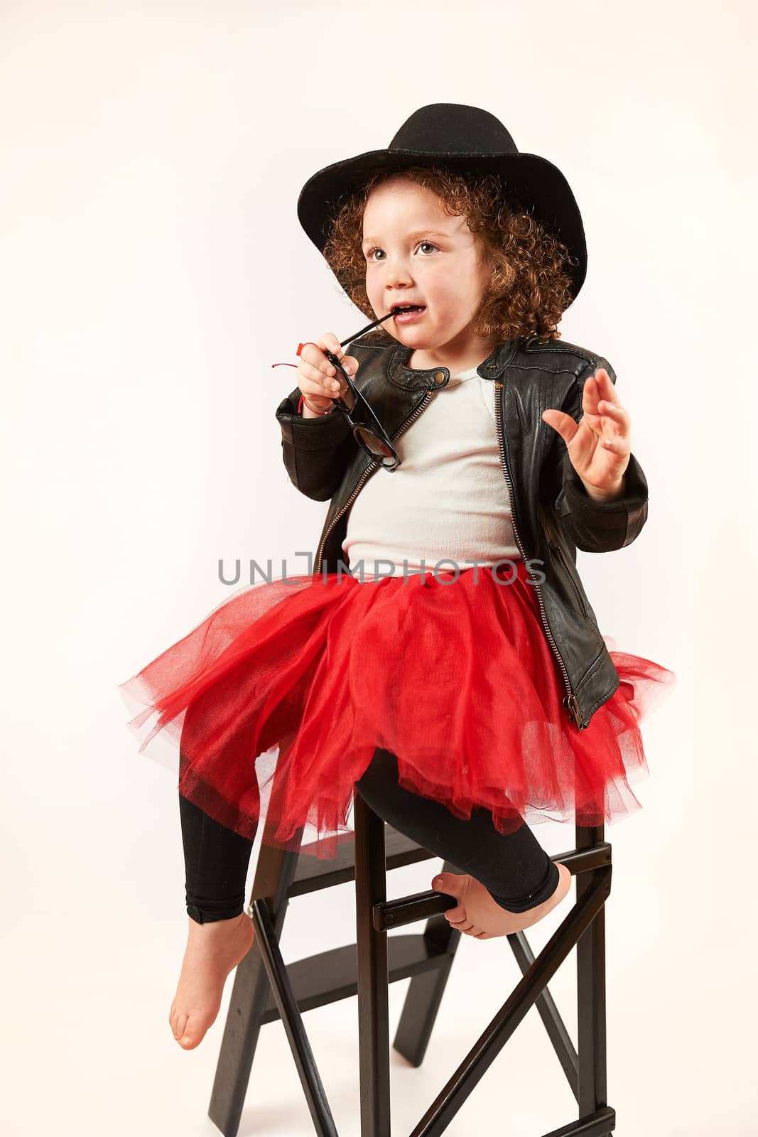 Little Girl Fashion Model With Black Hat by Multipedia