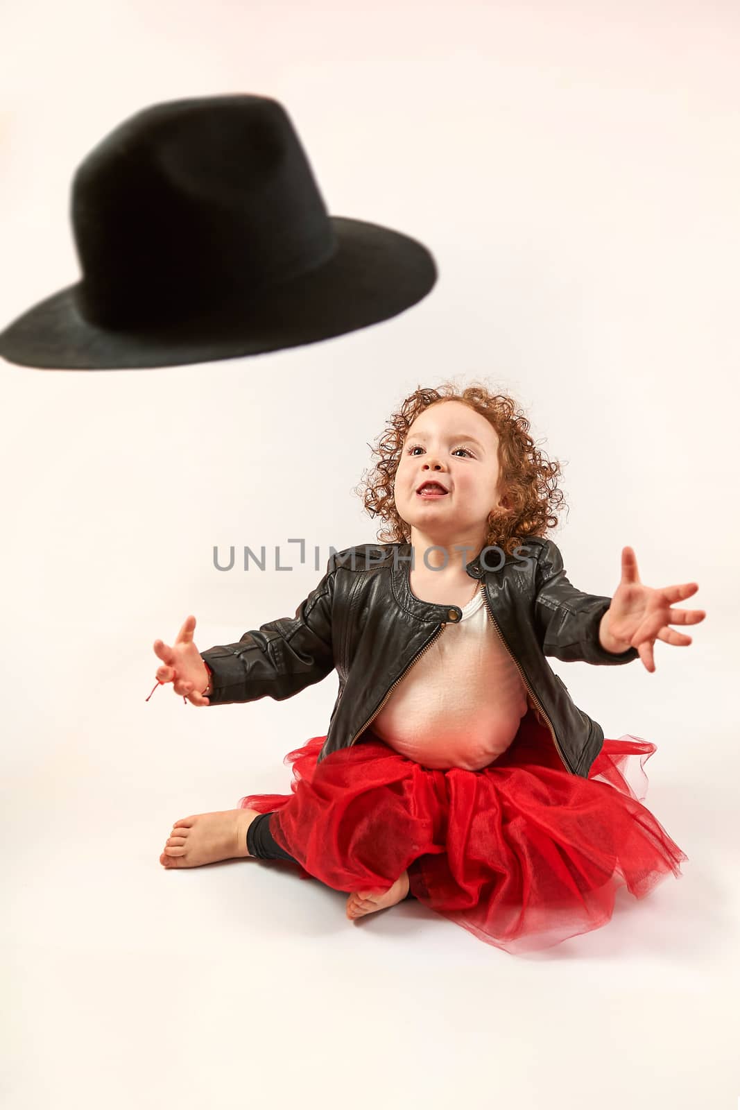 Little Girl Fashion Model With Black Hat by Multipedia