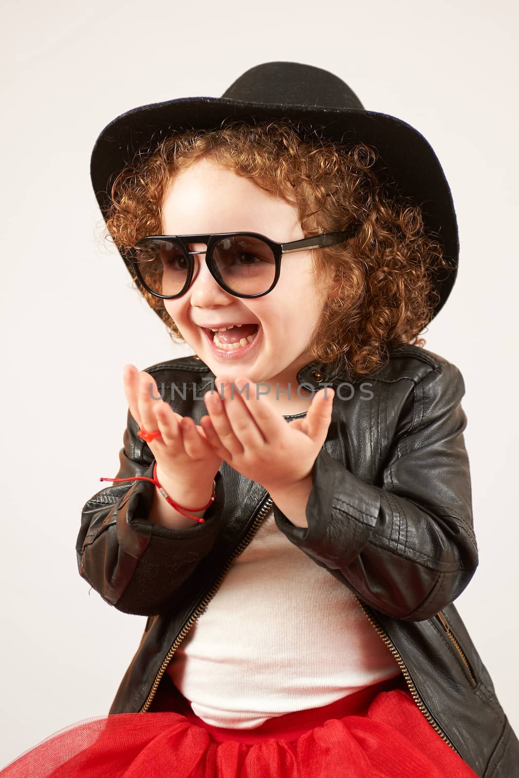 Little Girl Fashion Model With Black Hat by Multipedia