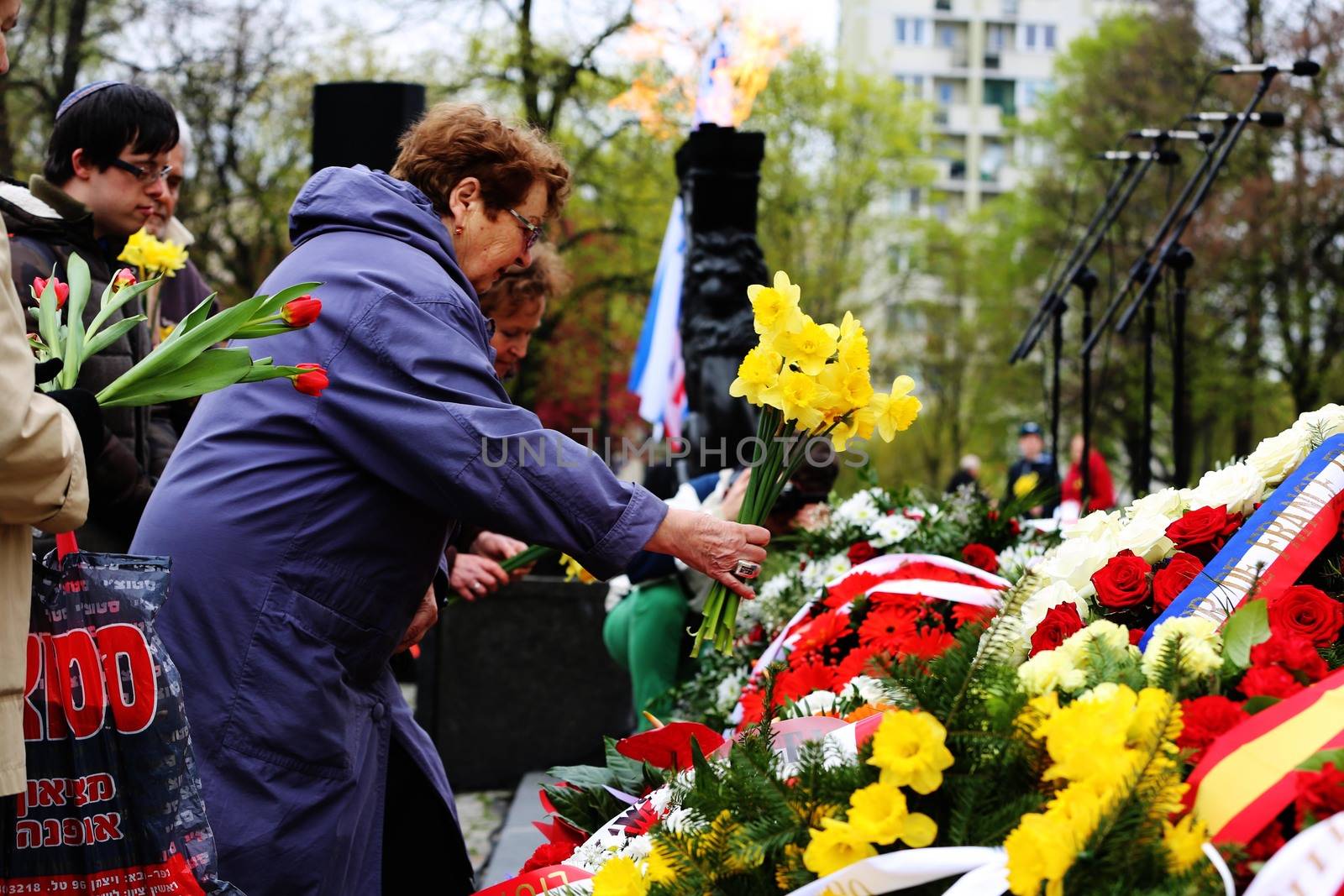 POLAND, Warsaw: People lay flowers at the Ghetto Heroes Monument in Warsaw, Poland on April 19, 2016, on the 73rd anniversary of the Warsaw Ghetto uprising.Members of the state and local governments, ambassadors, as well as those who are Righteous Among Nations attended the anniversary. The ceremony took place at the spot of the first armed clashes in 1943. The uprising started when Jewish residents of the ghetto refused surrender to the Nazi police commander. The entire ghetto was burned and the clashes ended on May 16. An estimated 13,000 people in the ghetto were killed in the revolt.