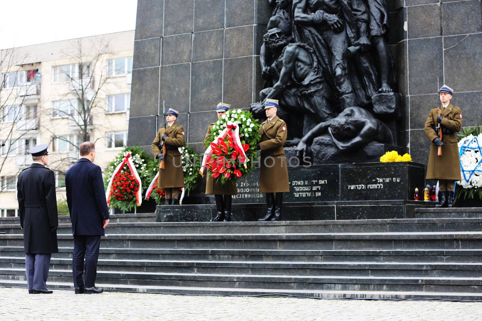 POLAND, Warsaw: An honor guard stands in front of the Ghetto Heroes Monument in Warsaw, Poland on April 19, 2016, on the 73rd anniversary of the Warsaw Ghetto uprising.Members of the state and local governments, ambassadors, as well as those who are Righteous Among Nations attended the anniversary. The ceremony took place at the spot of the first armed clashes in 1943. The uprising started when Jewish residents of the ghetto refused surrender to the Nazi police commander. The entire ghetto was burned and the clashes ended on May 16. An estimated 13,000 people in the ghetto were killed in the revolt.