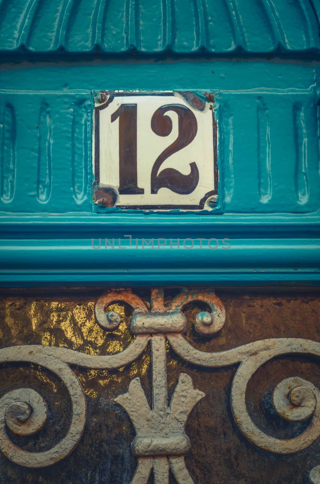 Detail Of An Apartment Number On A Rustic Blue Door In Paris