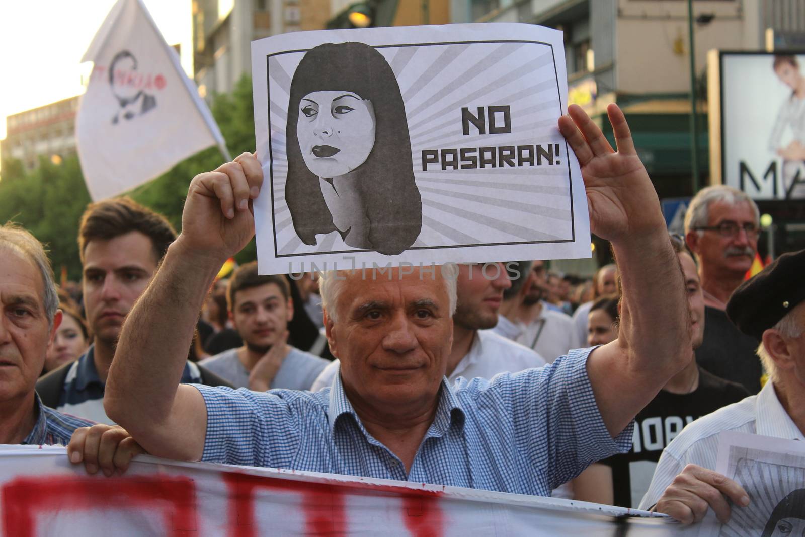 MACEDONIA, Skopje: A demonstrator raises a sign as thousands continue anti-government protests in Skopje, Macedonia on April 19, 2016. The protests began nearly one week ago, as demonstrators denounced President Gjorge Ivanov's decision to halt probes into more than 50 public figures involved in a wiretapping scandal. Meanwhile, snap elections have been called for June 5.