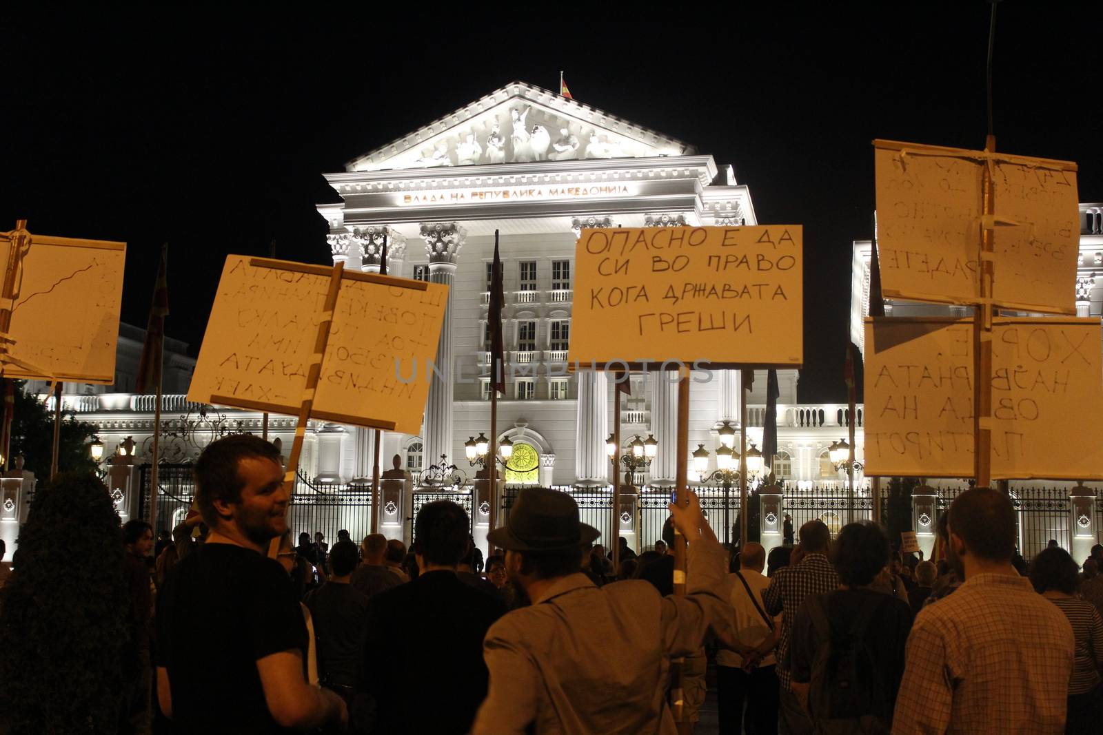 MACEDONIA, Skopje: Protesters raise signs outside a government building as thousands continue anti-government protests in Skopje, Macedonia on April 19, 2016. The protests began nearly one week ago, as demonstrators denounced President Gjorge Ivanov's decision to halt probes into more than 50 public figures involved in a wiretapping scandal. Meanwhile, snap elections have been called for June 5.