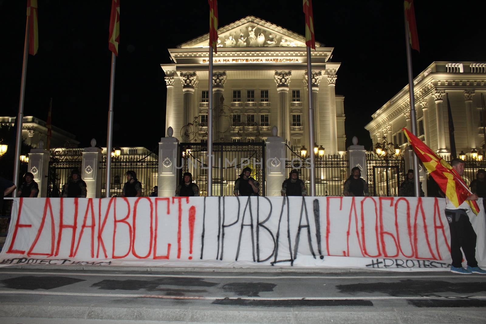 MACEDONIA, Skopje: A protest banner is plastered across the entrance of a government building as thousands carry on demonstrations in Skopje, Macedonia on April 19, 2016. The protests began nearly one week ago, as demonstrators denounced President Gjorge Ivanov's decision to halt probes into more than 50 public figures involved in a wiretapping scandal. Meanwhile, snap elections have been called for June 5.