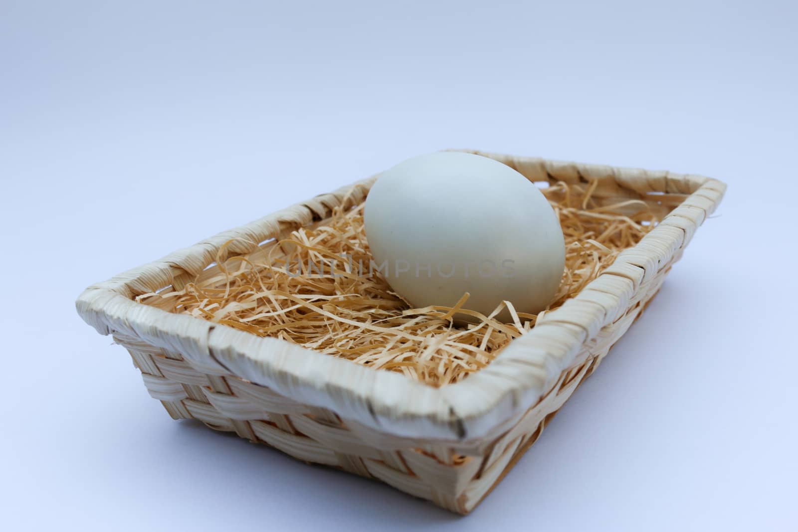 egg in basket wicker on white background by N_u_T