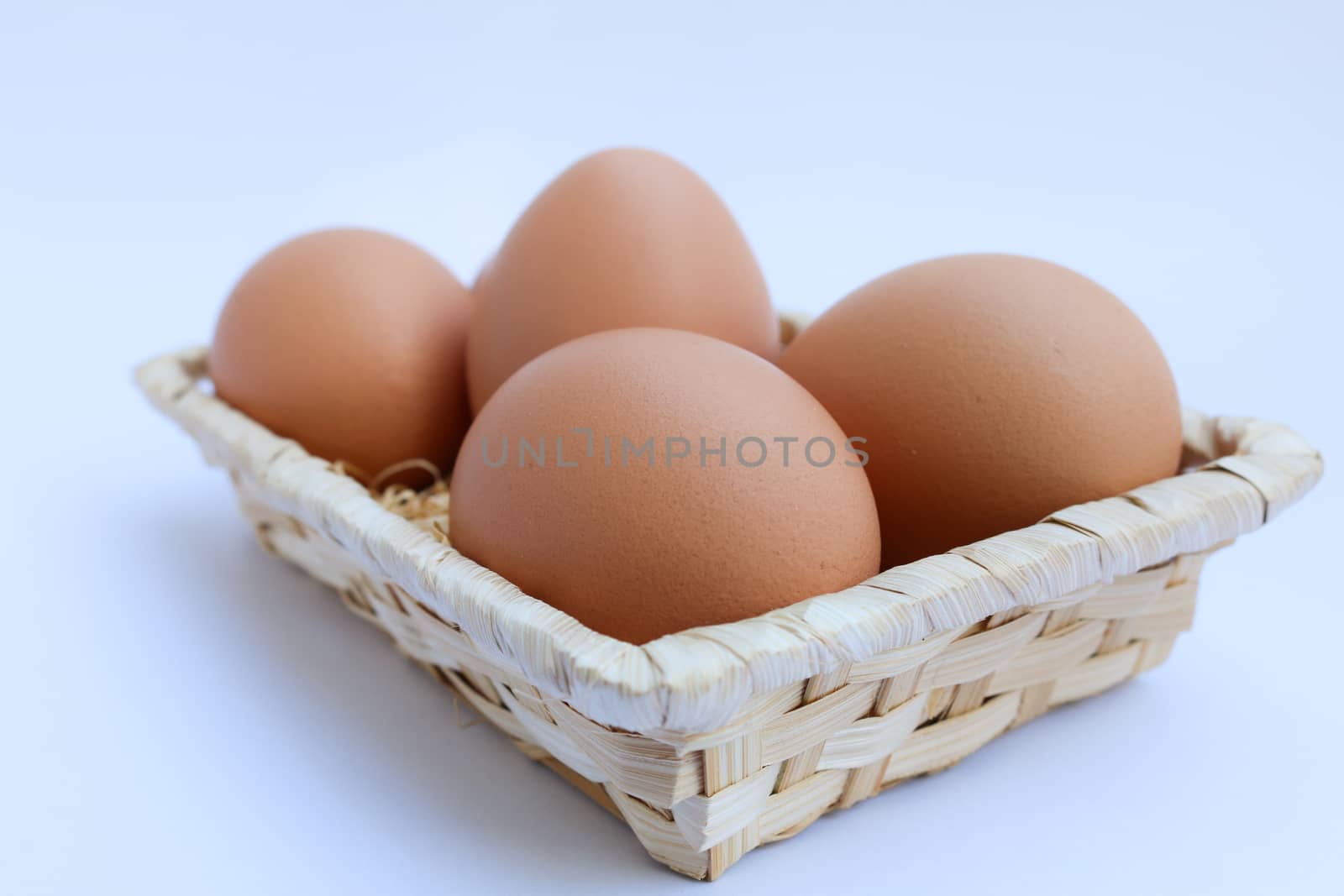 egg in basket wicker on white background