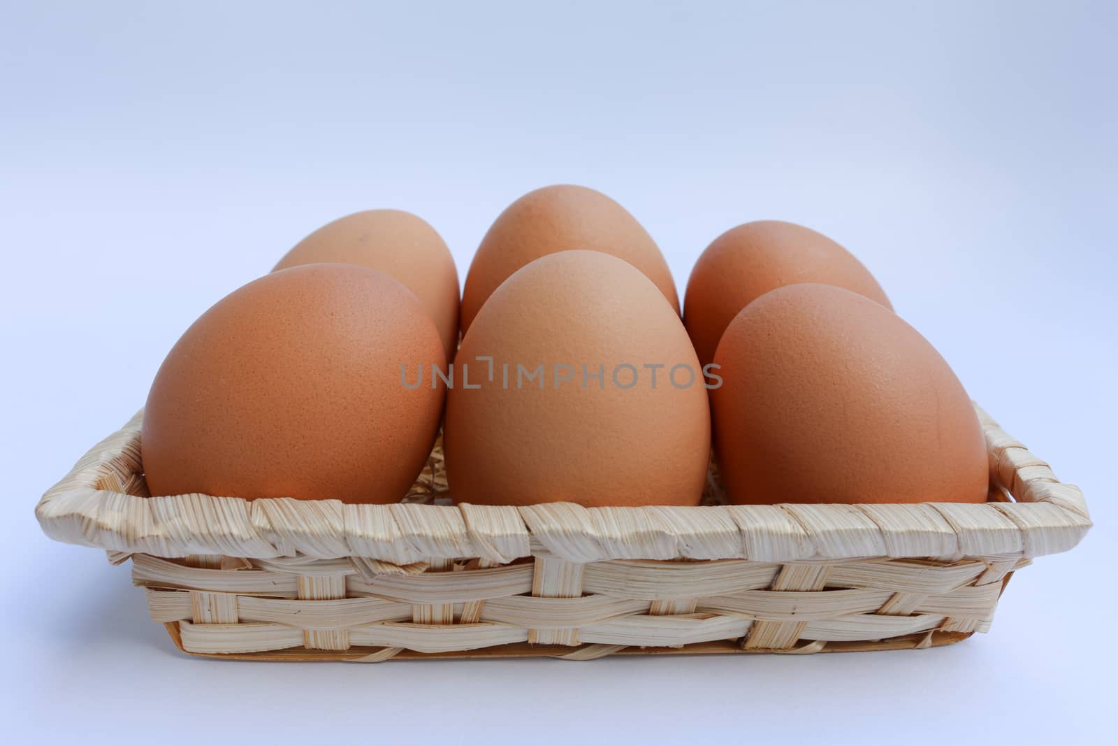 egg in basket wicker on white background by N_u_T