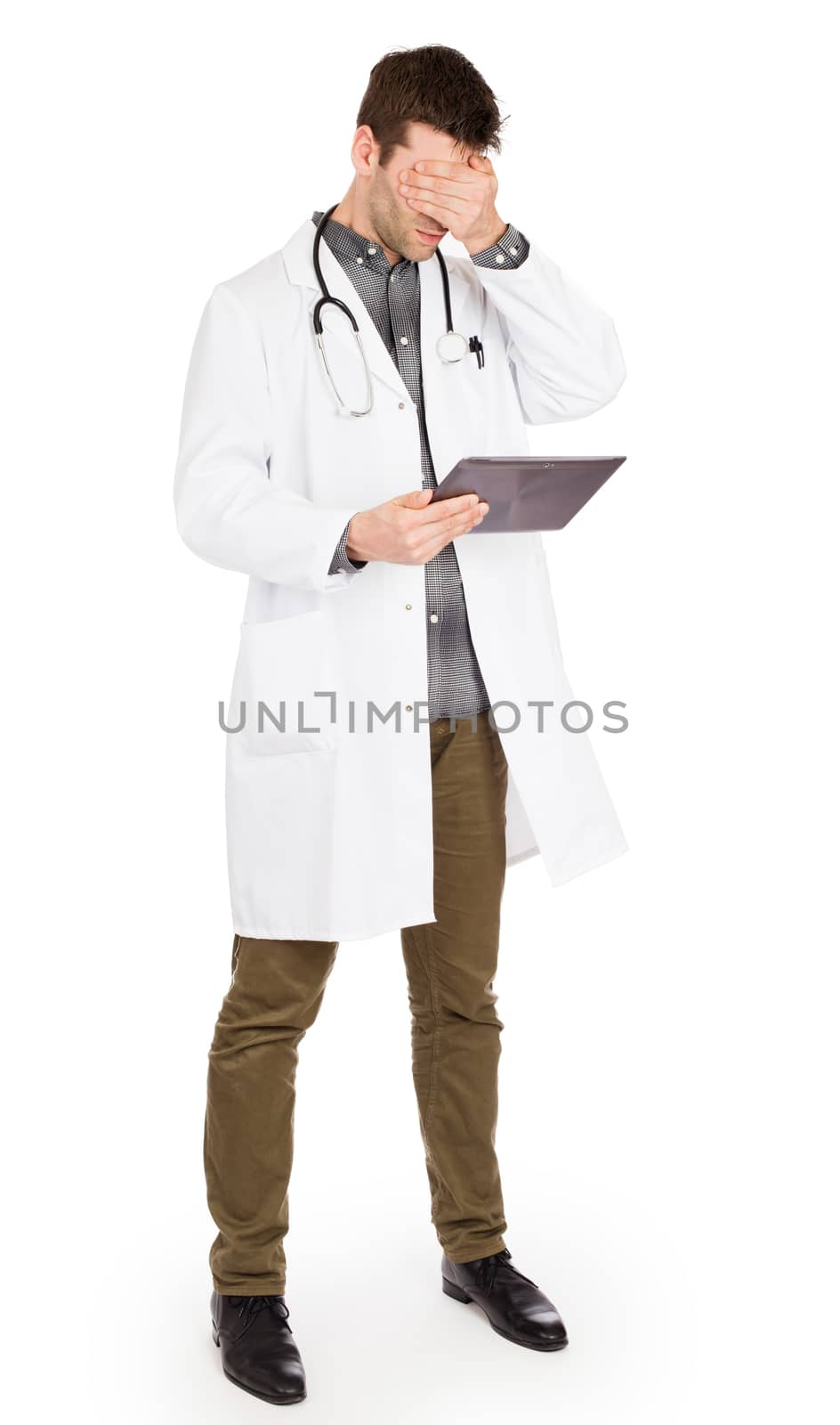 Male Caucasian doctor holding a digital tablet, looking shocked by michaklootwijk