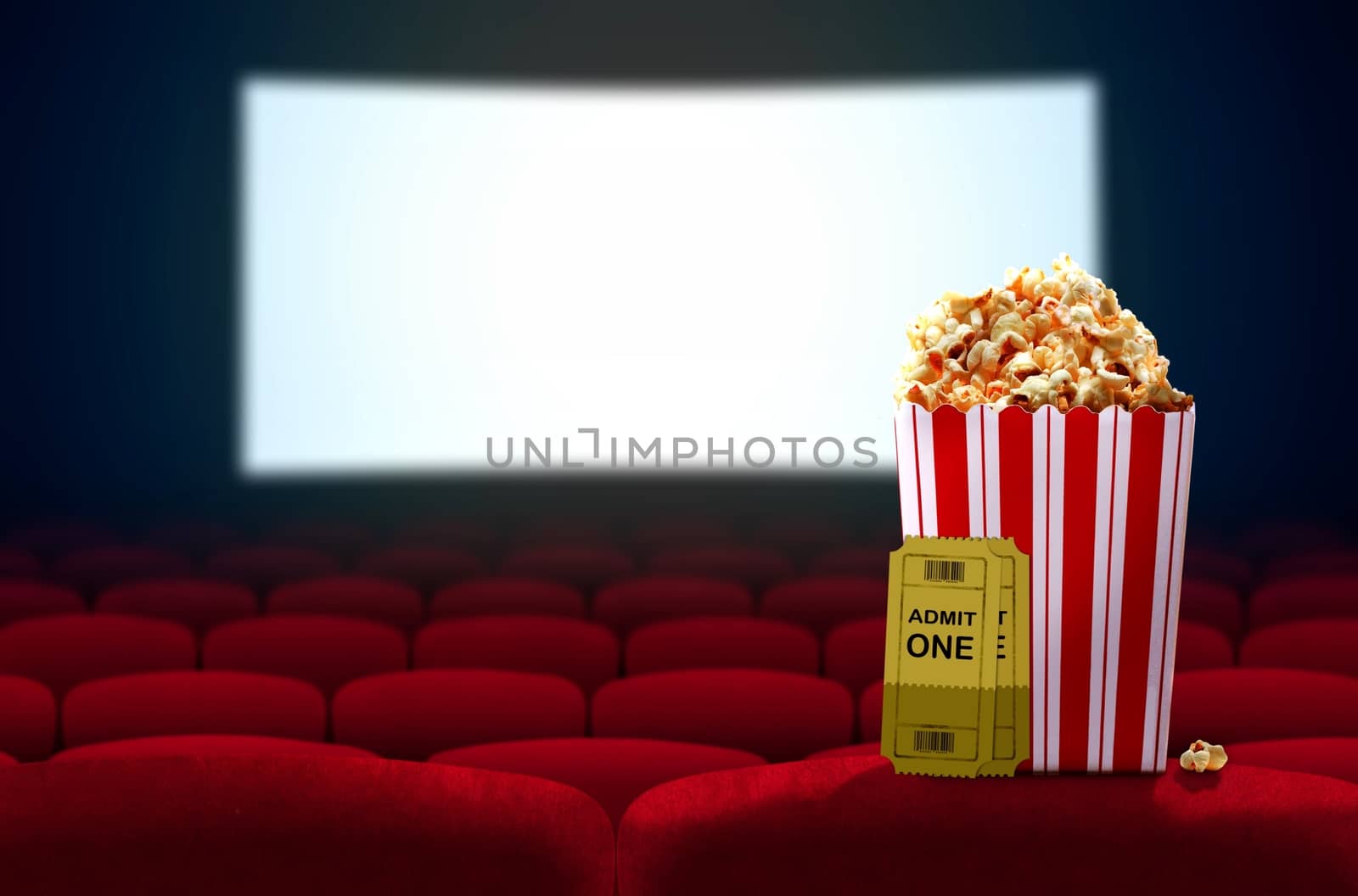 Cinema seat and pop corn facing empty movie screen by razihusin
