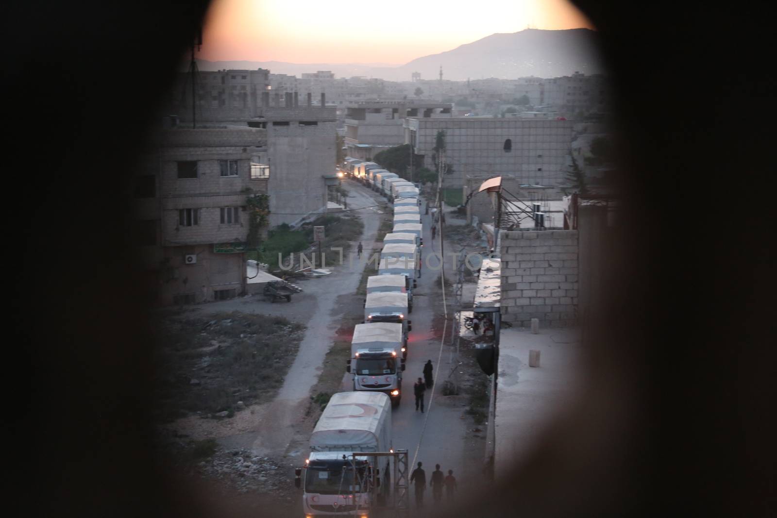 SYRIA, Saqba: Syrian Arab Red Crescent lorries carrying aid sent by the United Nations in the town of Saqba, in the eastern Ghouta area, a rebel stronghold east of the Syrian capital Damascus, on April 19, 2016.