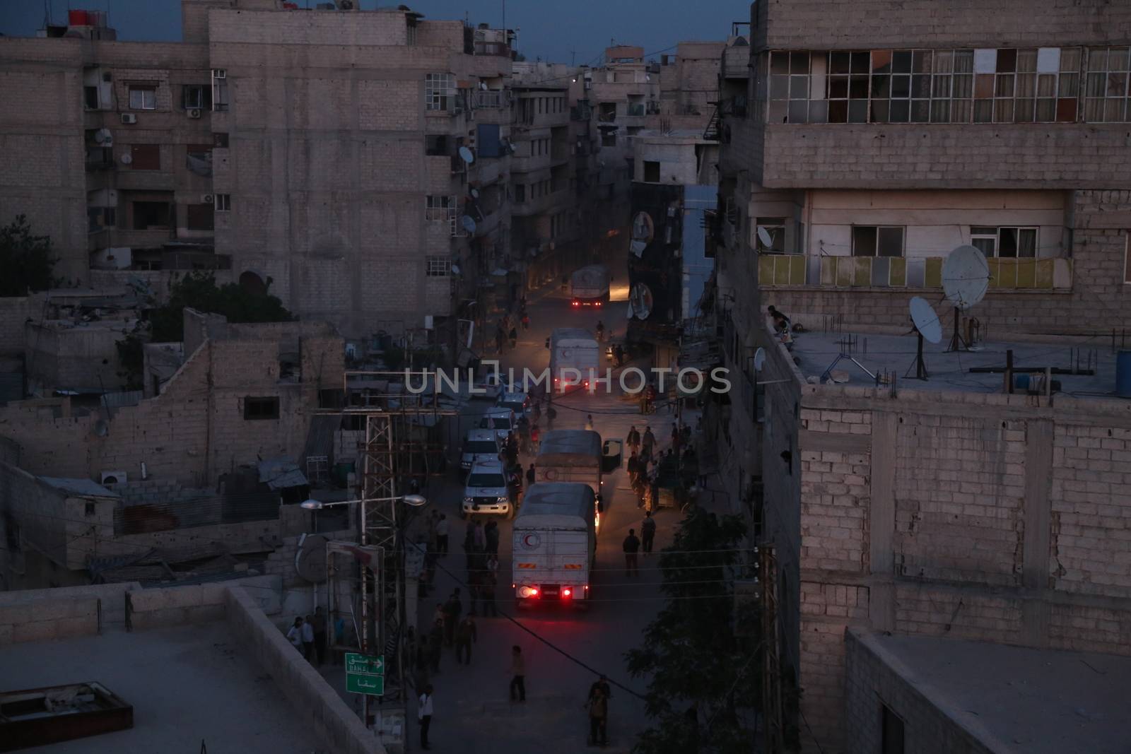 SYRIA, Saqba: Syrian Arab Red Crescent lorries carrying aid sent by the United Nations in the town of Saqba, in the eastern Ghouta area, a rebel stronghold east of the Syrian capital Damascus, on April 19, 2016.