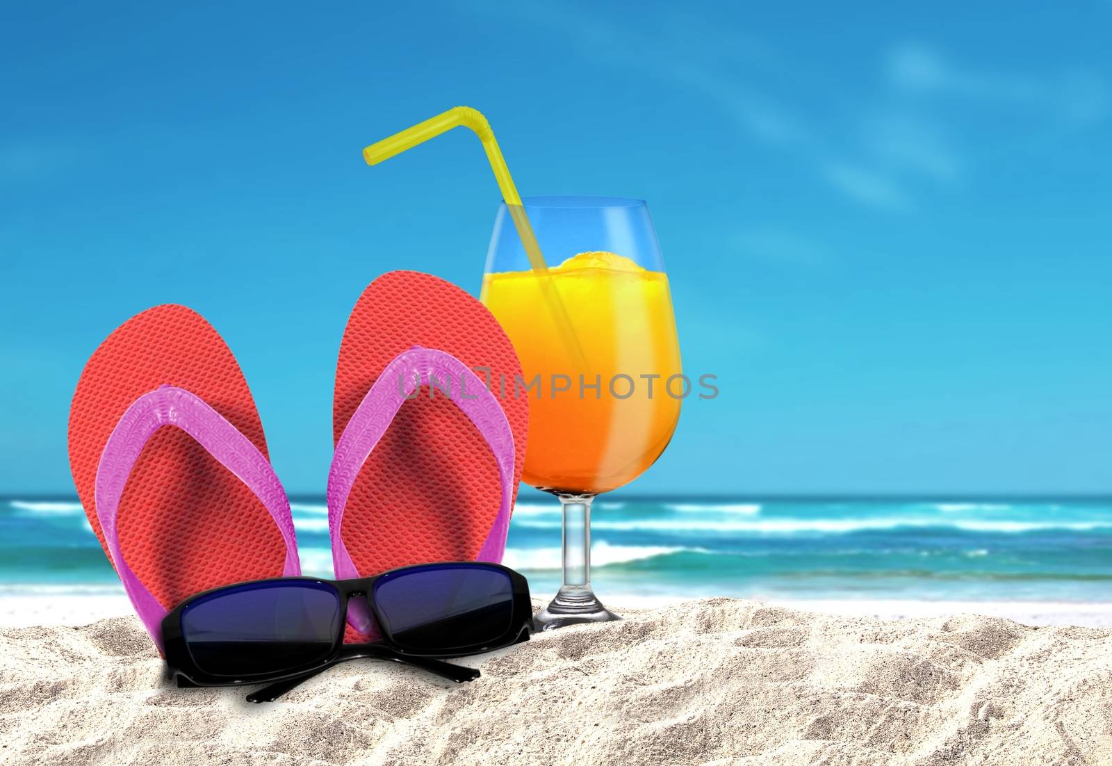 Slipper with sungalsses and orange drinks on a beach