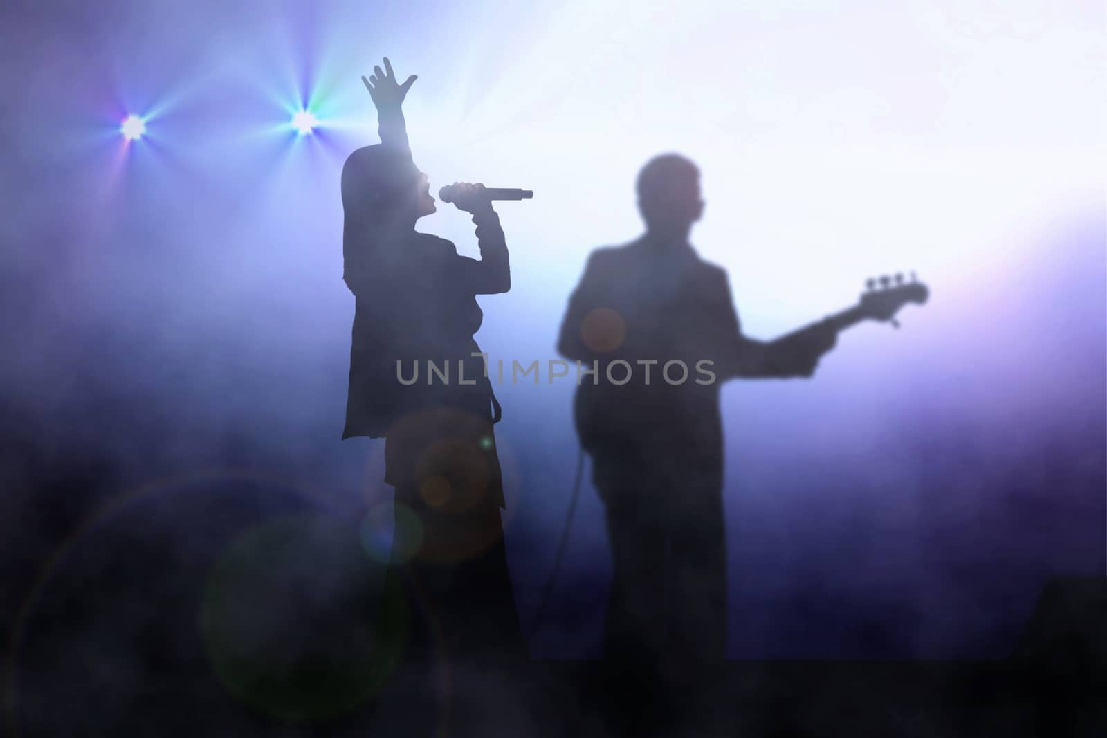 Women on stage singing with guitarist under spotlight by razihusin