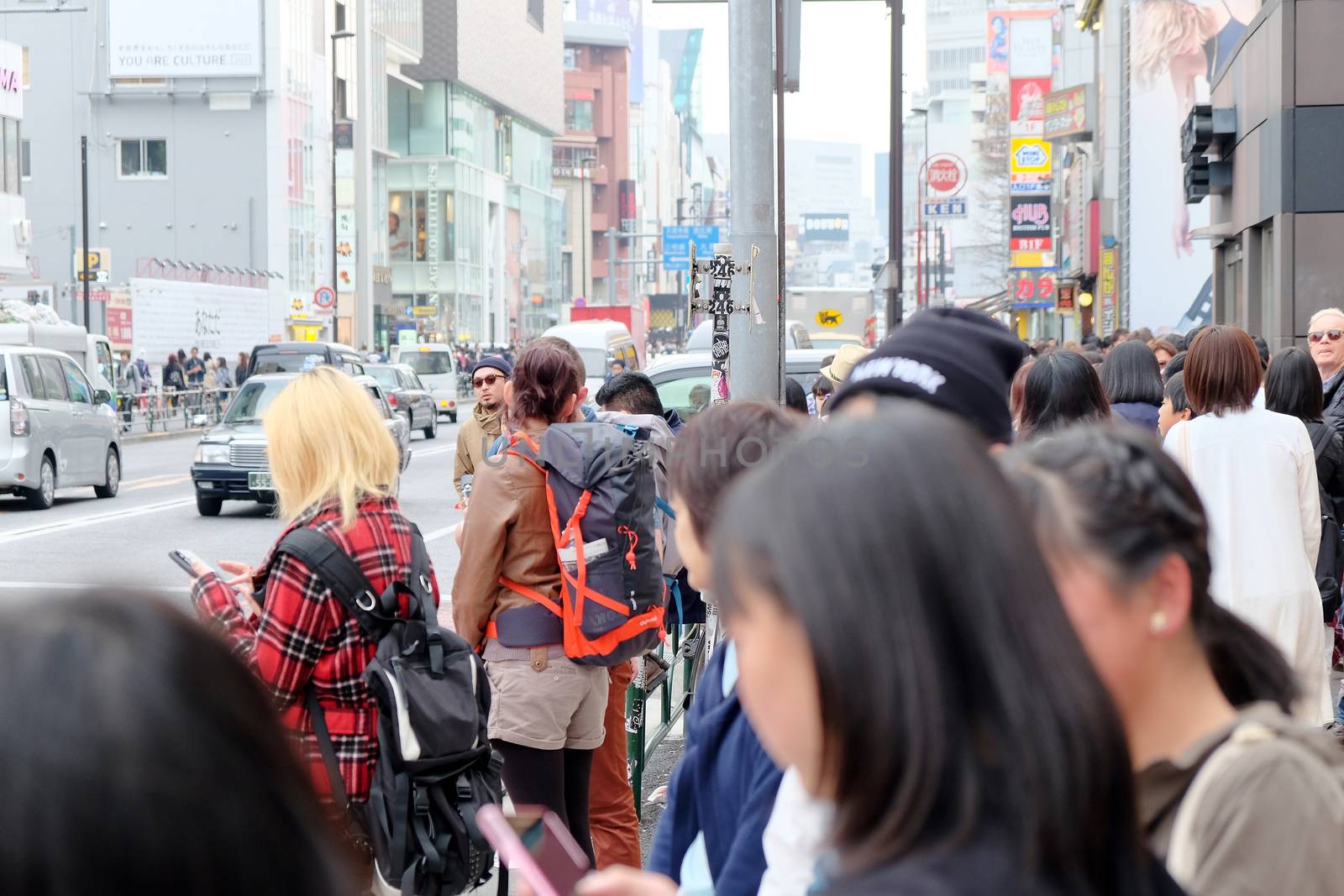 Tokyo, Japan - March 30, 2016 Crowds of pedestrians crossing the busy downtown streets of Harajuku, Harajuku is known as a center of Japanese youth culture and fashion.