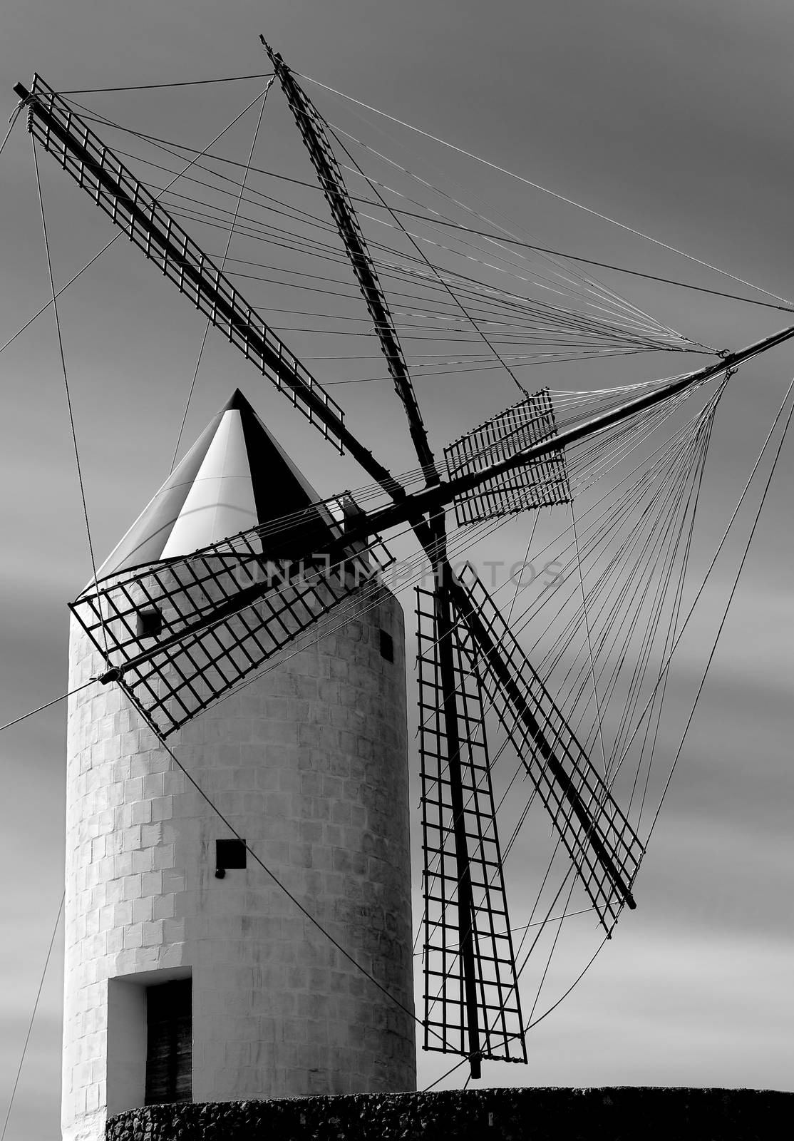 Beautiful Old Spanish Windmill on Cloudy Sky background in Menorca, Balearic Islands. Black and White Toned