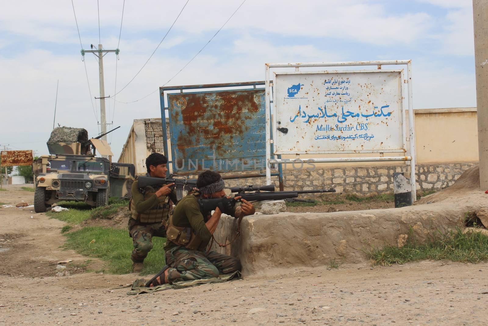 AFGHANISTAN, Alchin: Soldiers of Afghan national army (ANA) fight back Taliban militants in Alchin village, in Kunduz province, in northern Afghanistan on April 16, 2016. Afghan security forces drove Taliban fighters back from Kunduz city, officials said, as the insurgents began the 2016 fighting season by targeting the northeastern provincial capital they briefly captured last year. At least 64 people were killed and hundreds wounded when a Taliban truck bomb tore through central Kabul and a fierce firefight broke out on April 19, 2016 one week after the insurgents launched their annual spring offensive. The brazen assault near the defence ministry marks the first major Taliban attack in the Afghan capital since the insurgents announced the start of this year's fighting season. (The photographer is embedded with ANA)  