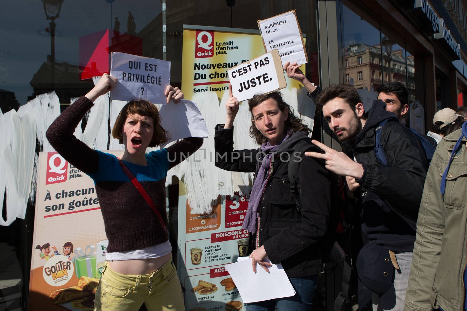 FRANCE, Paris : Demonstrators part of the Nuit Debout movement face police officers during a protest against split shifts and to demand wage increases in front of a fast food restaurant in Paris on April 20, 2016. 