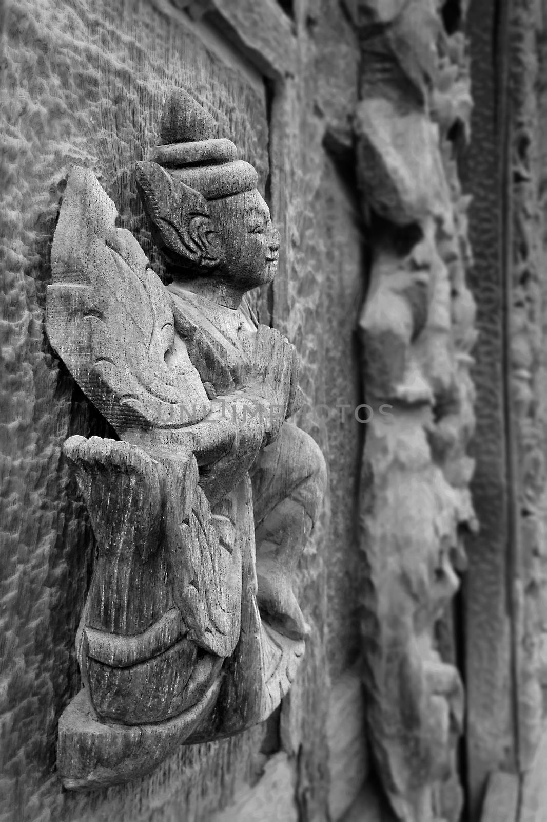 MANDALAY,MYANMAR-APR 19 : Carved wooden figure at Shwenandaw Monastery (Golden Palace Monastery) in Mandalay, Myanmar. Golden Palace Monastery was built in 1880 (The traditional Burmese architectural style)  on April 19,2013,Mandalay city in Myanmar.