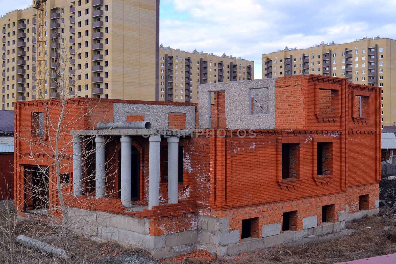 The unfinished cottage costs against high-rise buildings. Tyumen by veronka72