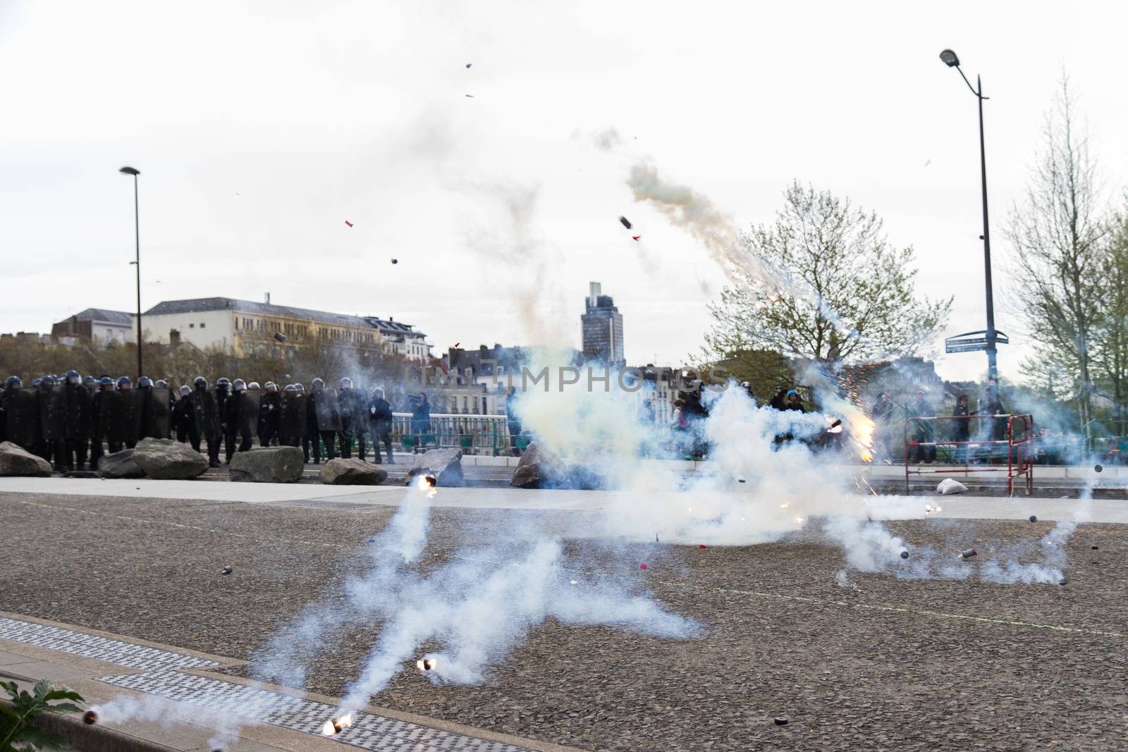 FRANCE, Nantes : Protesters face riot police on April 20, 2016 in Nantes, western France, as they protest against the government's planned labour law reforms.High school pupils and workers protest against deeply unpopular labour reforms that have divided the Socialist government and raised hackles in a country accustomed to iron-clad job security.