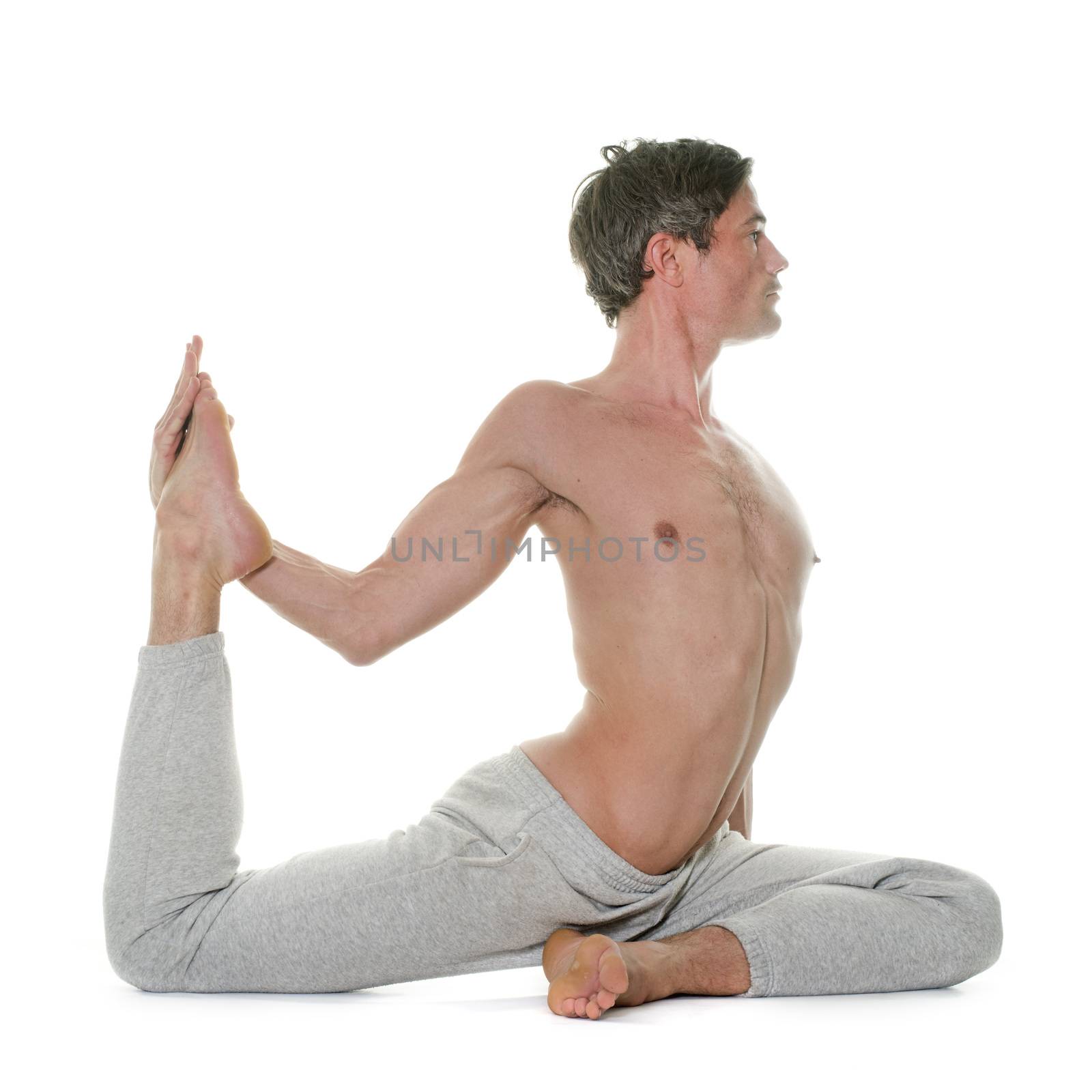 man doing yoga in front of white background