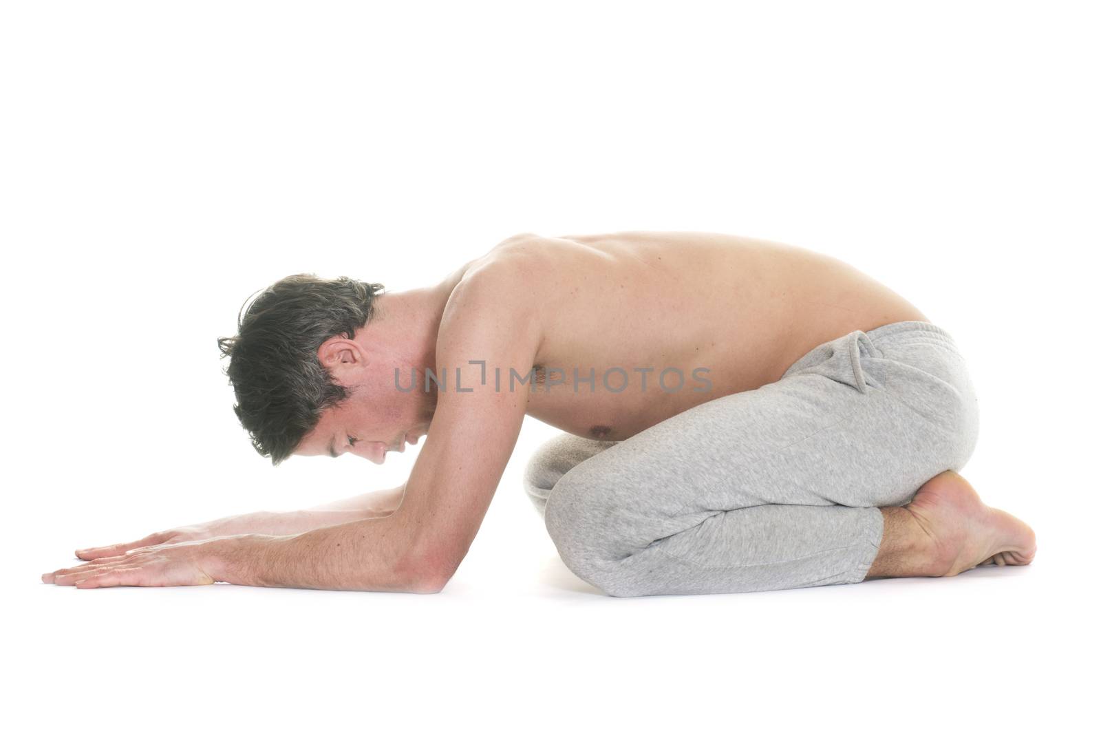 man doing yoga in front of white background