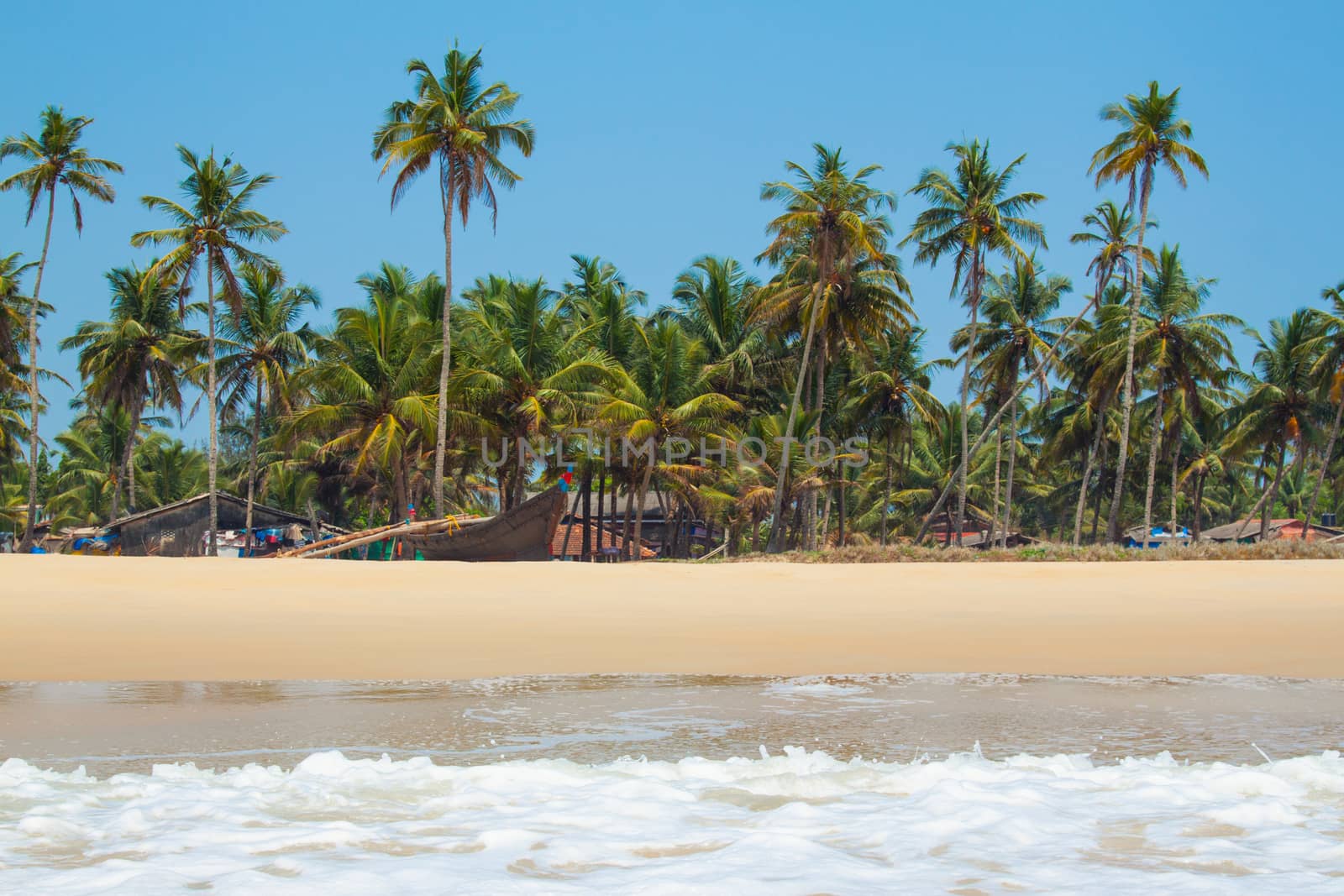 Kolva, India - April 20, 2016: Goan beach panorama with sea, fisherman boats and palms