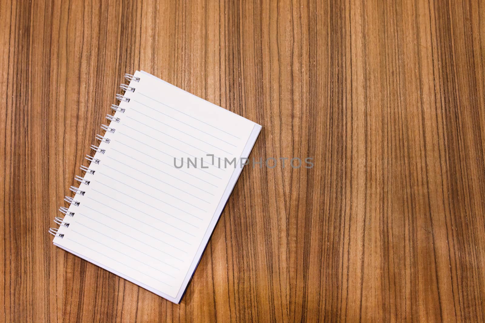 Blank note book on wood table concept and Idea for write your te by nopparats