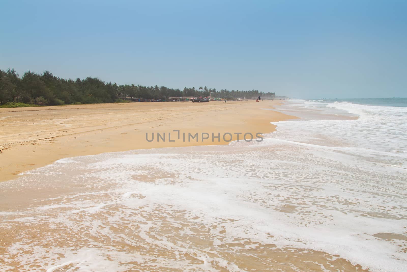 Kolva, India - April 20, 2016: Goan beach panorama with sea, fisherman boats and palms