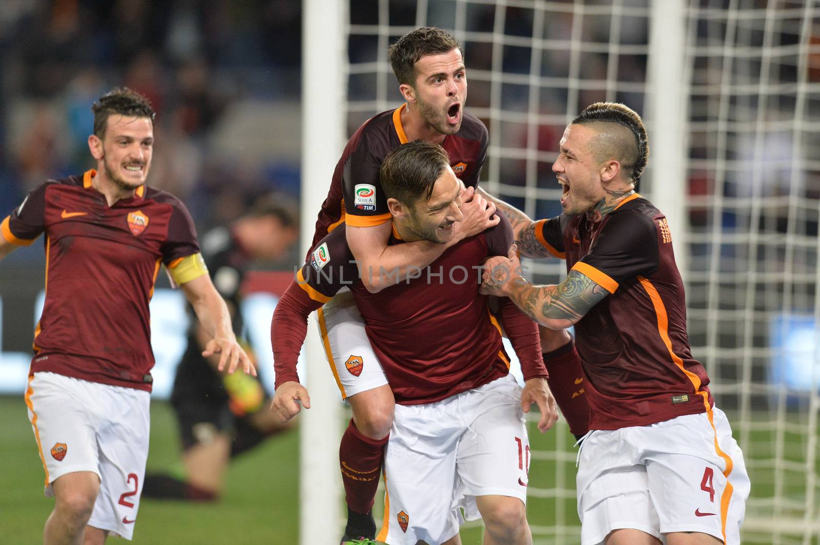 ITALY, Rome: Francesco Totti with his teammates of AS Roma celebrates after scoring the team's third goal from penalty spot during the Serie A match between AS Roma and Torino FC at Stadio Olimpico on April 20, 2016 in Rome, Italy.
