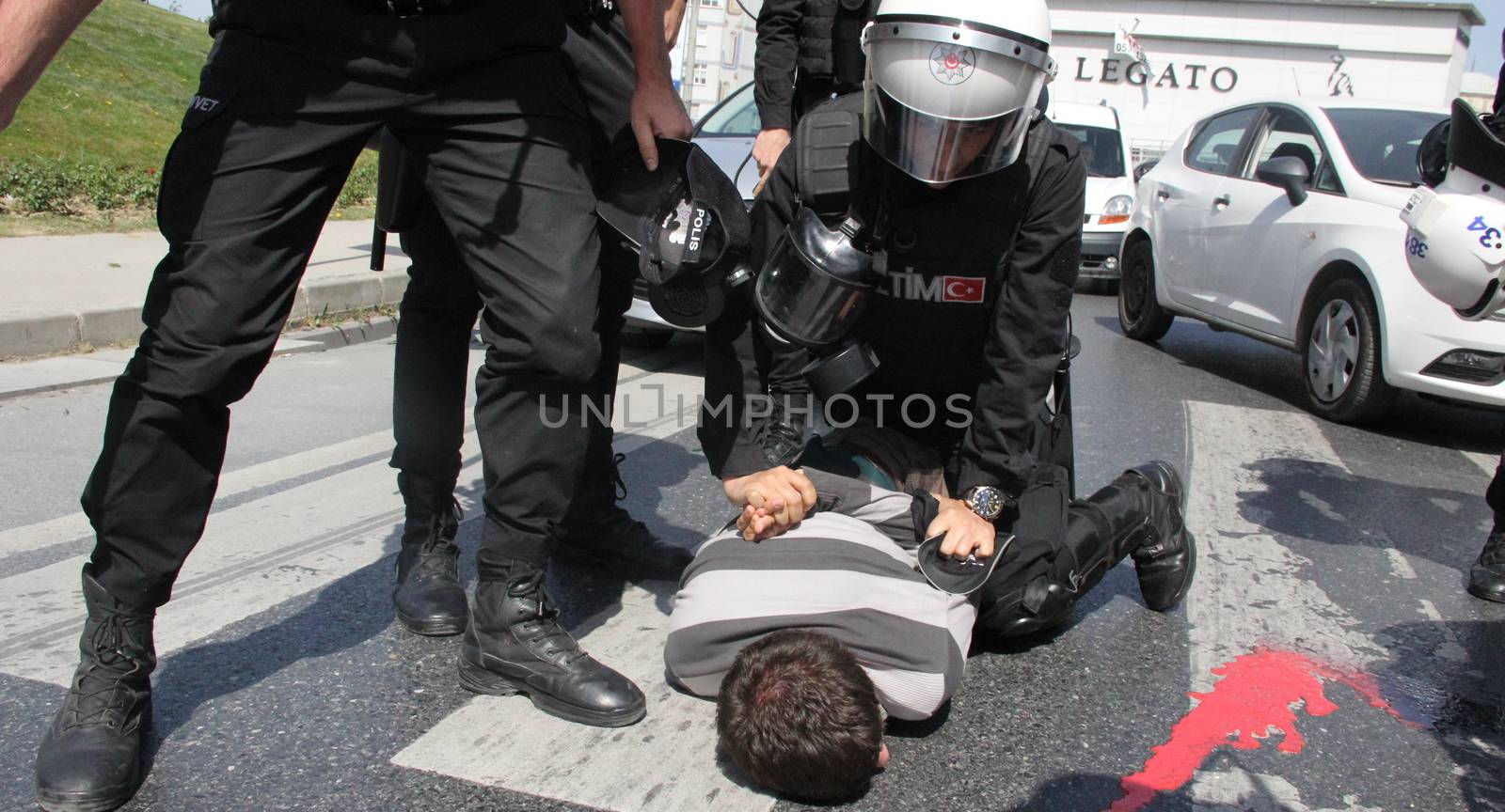 TURKEY, Istanbul: A policeman arrests a protester outside the courthouse in Istanbul, Turkey, on April 20, 2016, during the second hearing in the trial of a police officer accused of killing Dilek Doğan. Dogan died after being shot dead during a police raid of her family's house in Istanbul's Sariyer district, last October. Dozens of protesters, who shouted Murderers of Dilek must be tried, has been taken into custody by police. 