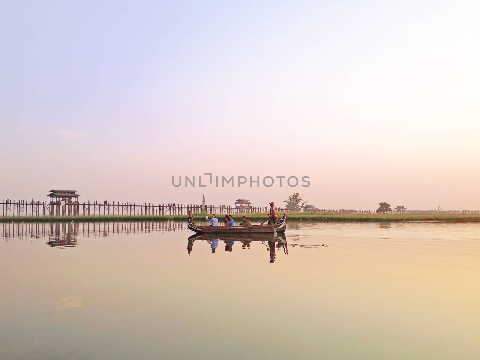 Sunset U Bein Bridge, Myanmar-21 APRIL2013:Sightseeing at U Bein bridge, Lake in Amarapura, Mandalay, Myanmar. U Bein bridge is the oldest and longest teakwood bridge in the world.