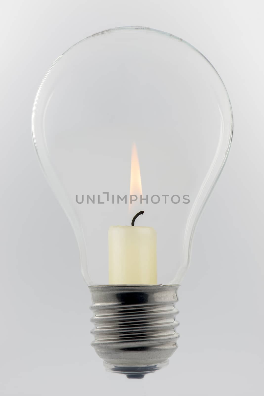 Conceptual glass light bulb with burning candle
 by Tofotografie