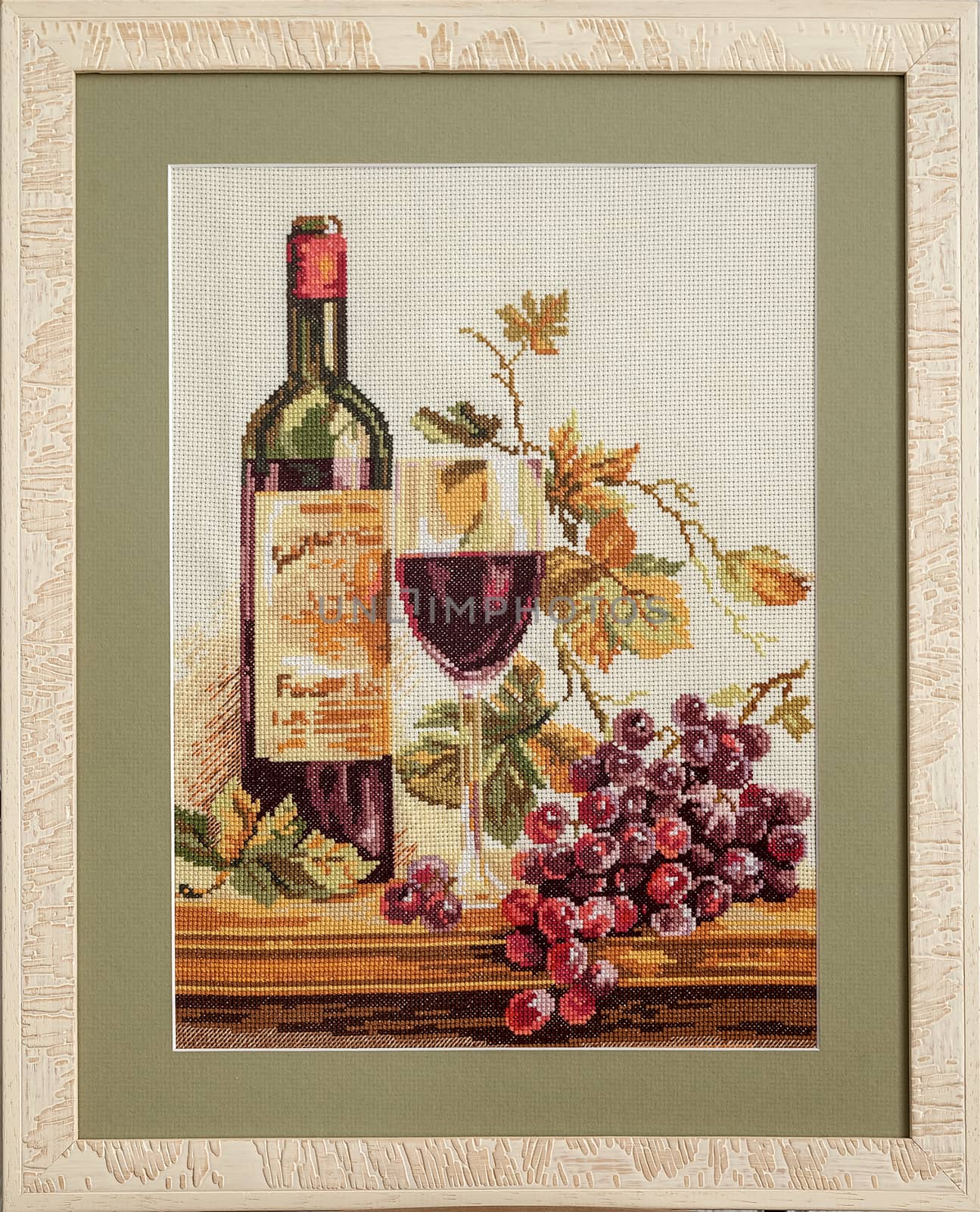 Heaps of beads lying on the canvas, embroidered pattern and frame