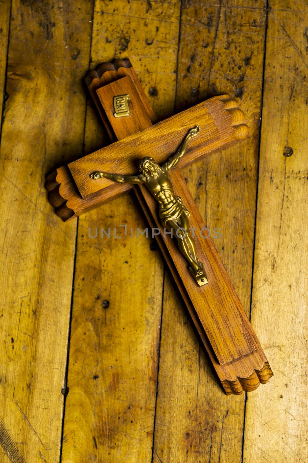 Jesus on the cross isolated on wooden floor