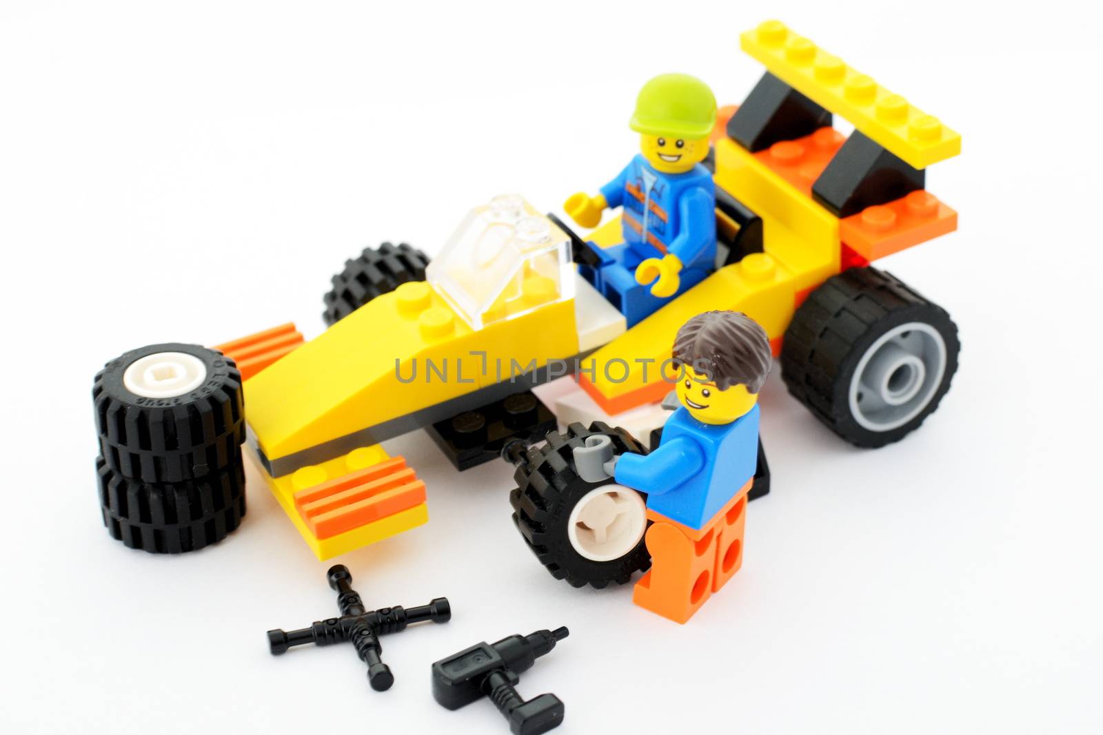 WROCLAW, POLAND - FEBRUARY 28: Formula driver waits while mechanic changes tires in Lego sports car on 28th February in Wroclaw, Poland.