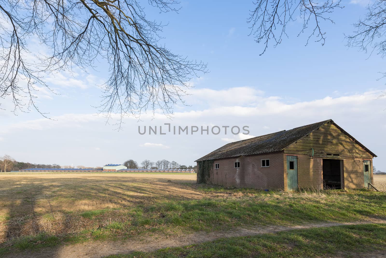 Modern barn with solar collectors and old barn
