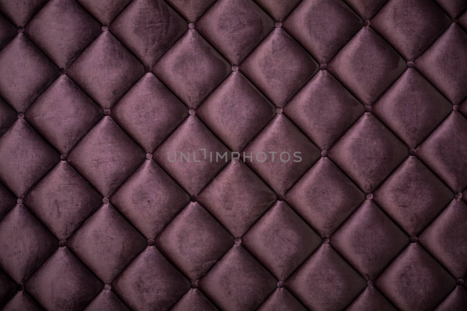 close up of silk burgundy sofa