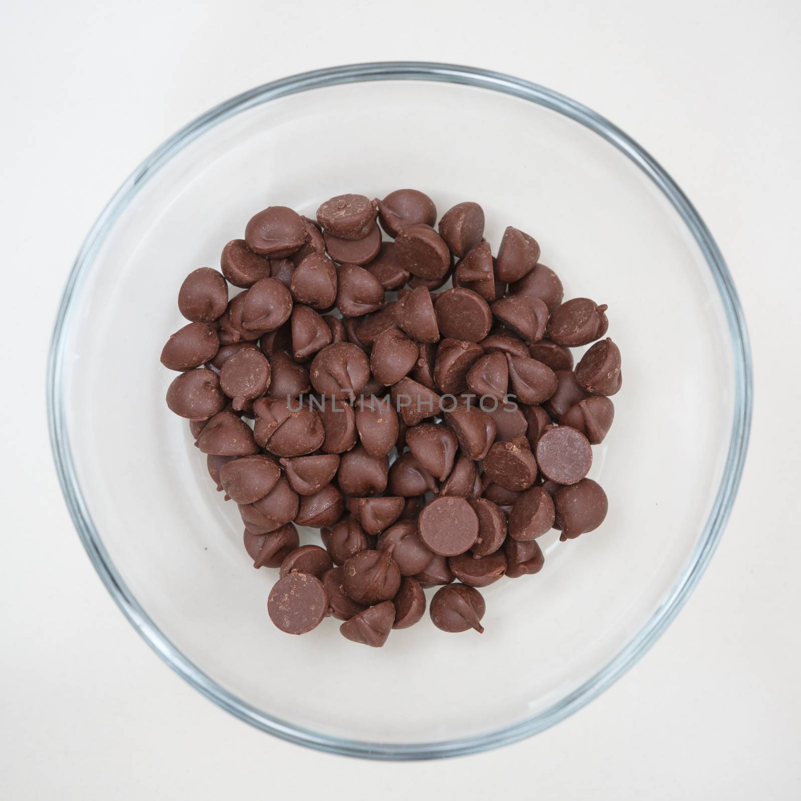 close up of chocolate chips in glass bowl