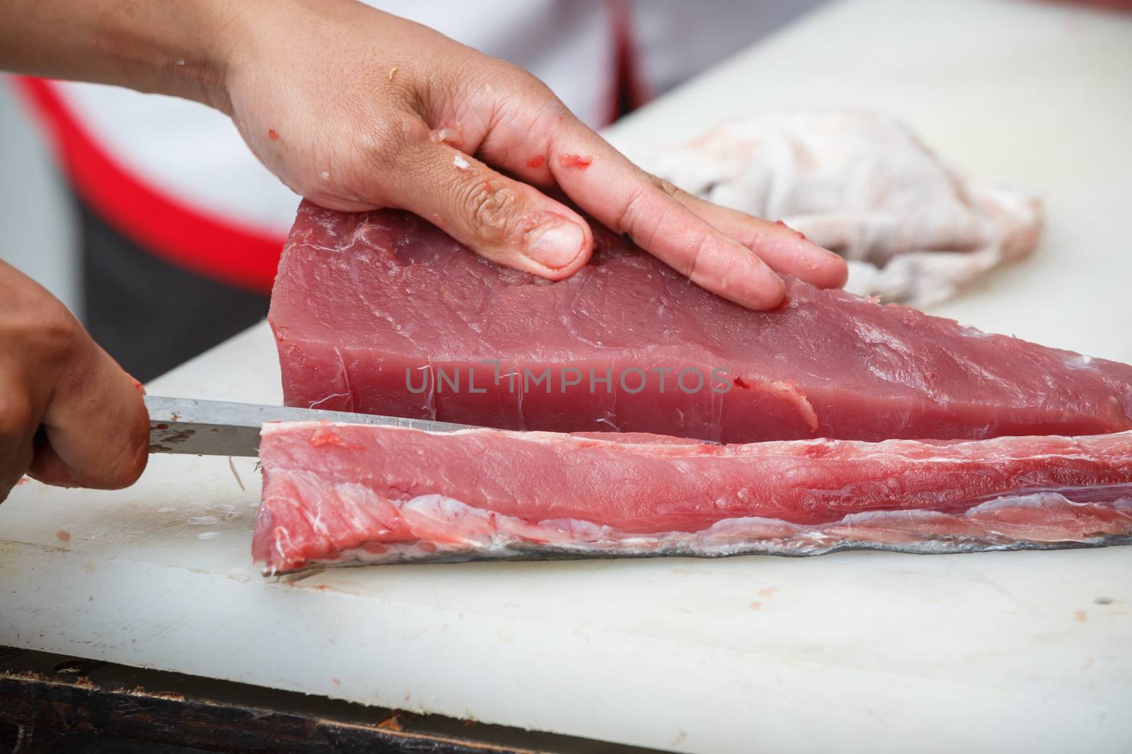 cutting tuna on a white table