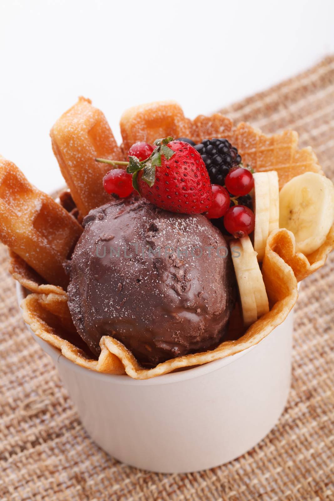 vaniila waffle with chocolate ice cream decorate with mix berry and banan