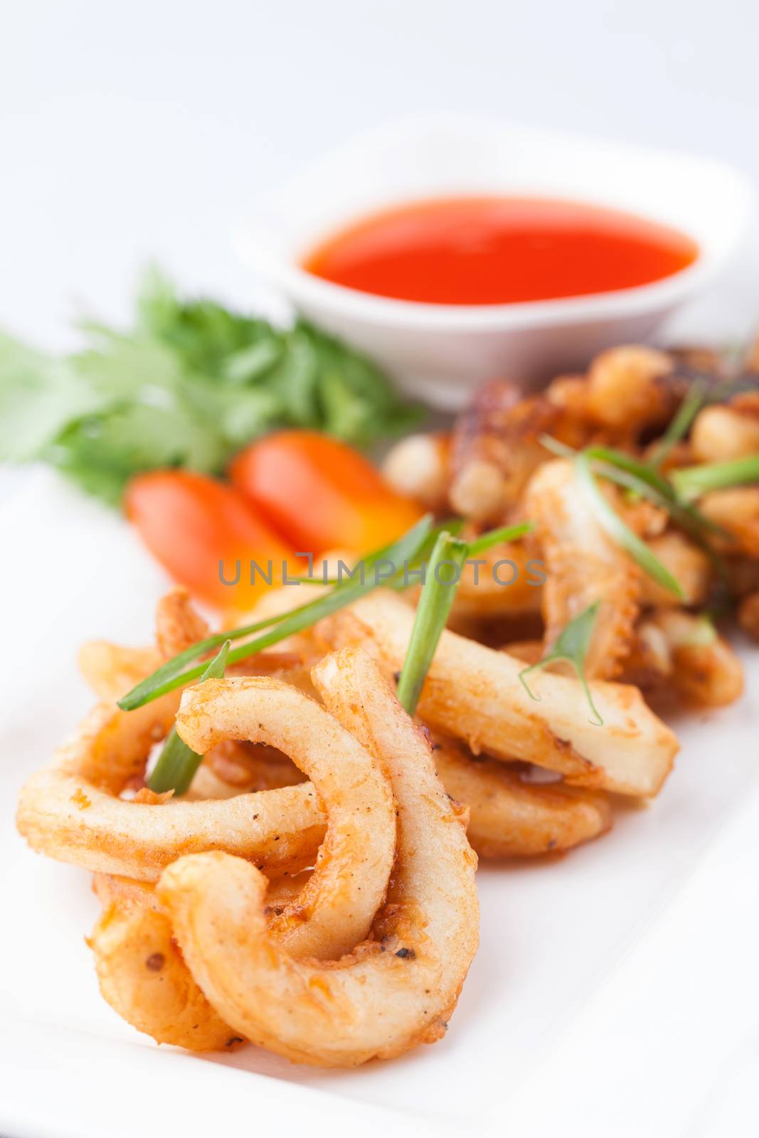 fried octopus with chili sauce on white plate