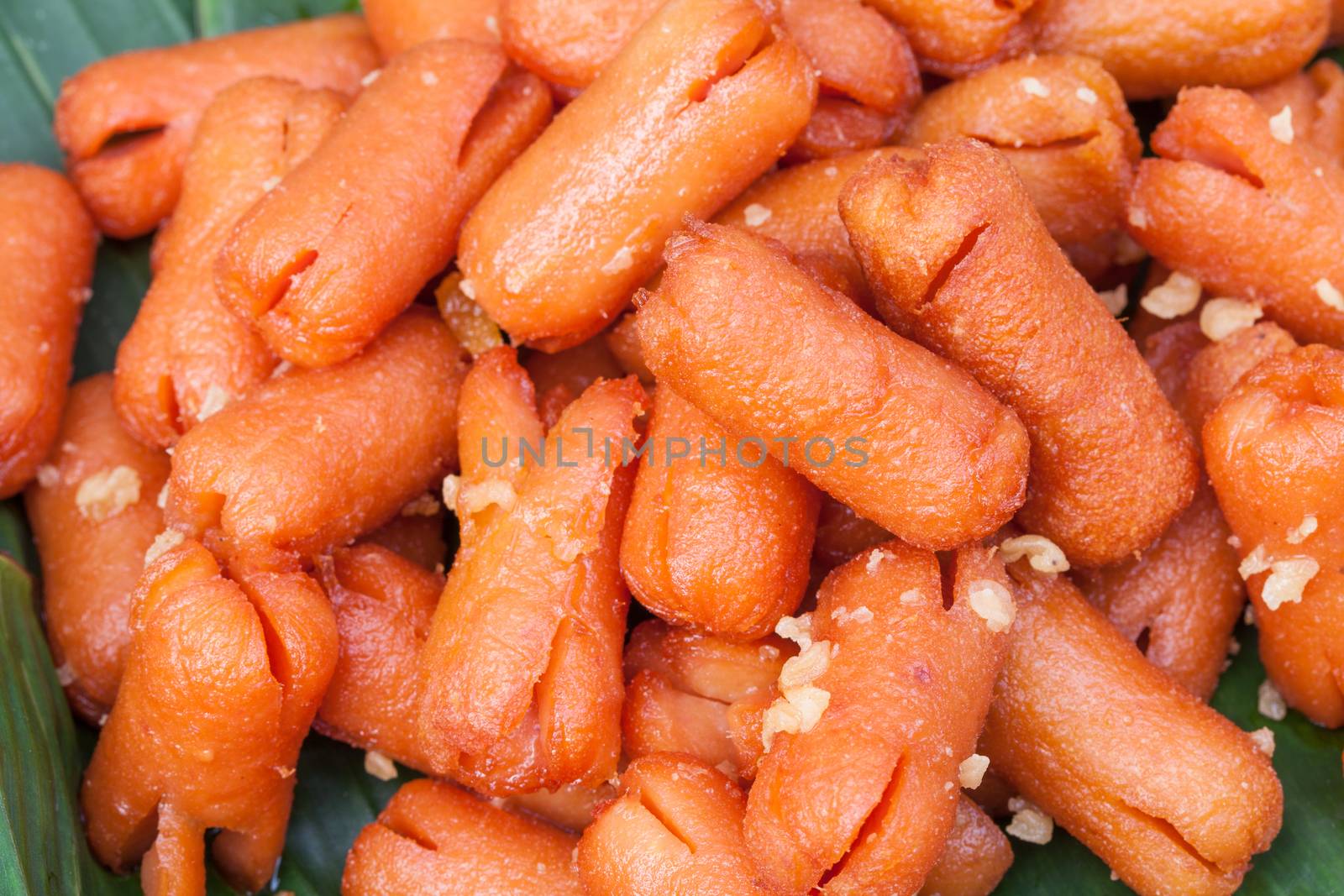 fried mini sausage on  banana leaf