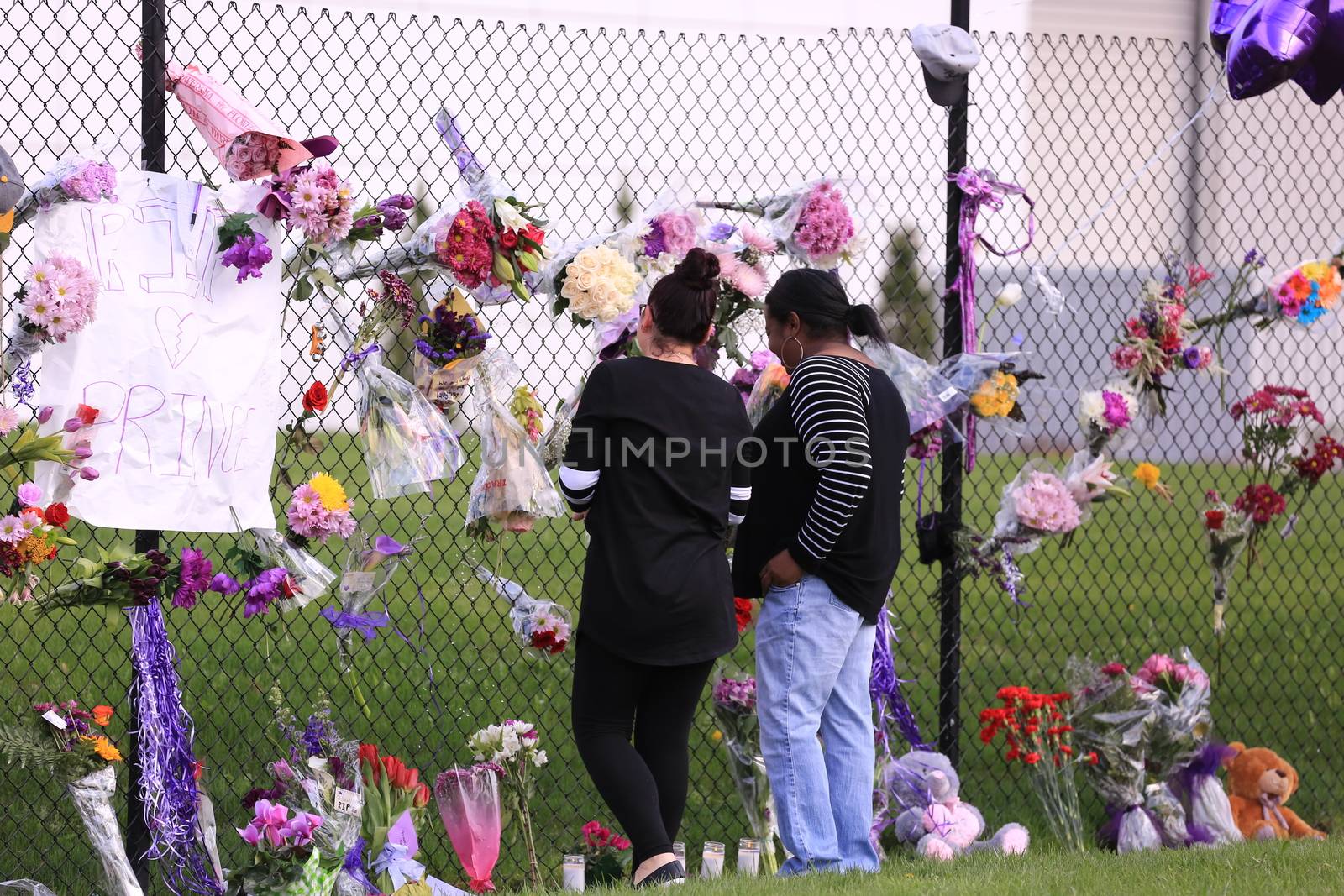 MINNESOTTA, Chanhassen: Fans pay their respects outside the Paisley Park residential compound of music legend Prince in Chanhassen, near Minneapolis, Minnesota, on April 21, 2016. Emergency personnel tried and failed to revive music legend Prince, who died April 21, 2016, at age 57, after finding him slumped unresponsive in an elevator at his Paisley Park studios in Minnesota, the local sheriff said.
