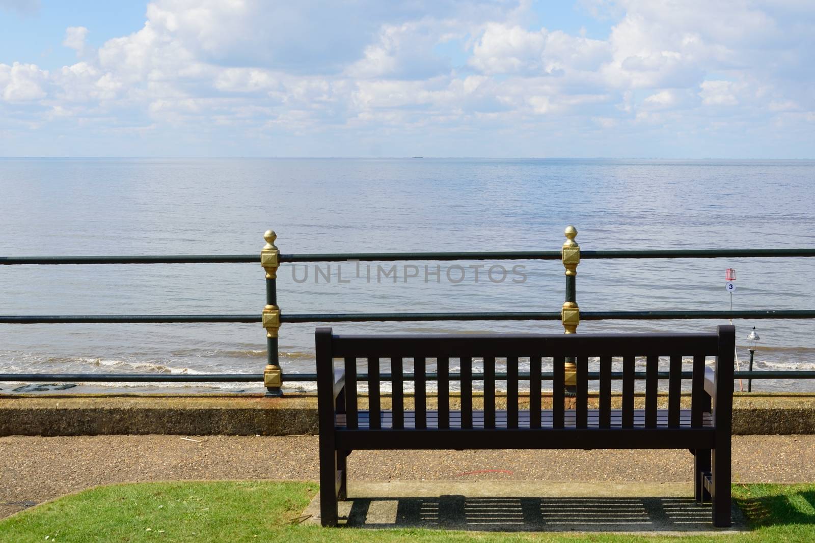 Empty wooden Bench overlooking Beach