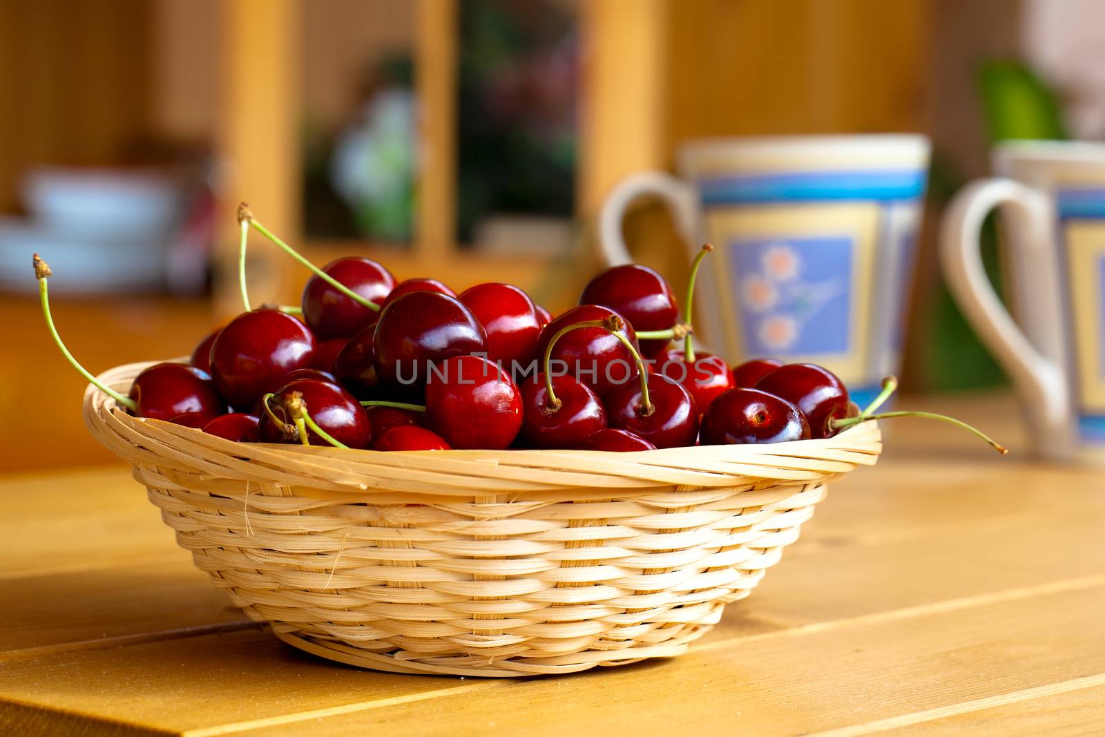 wicker basket with fresh sweet cherries  by motorolka