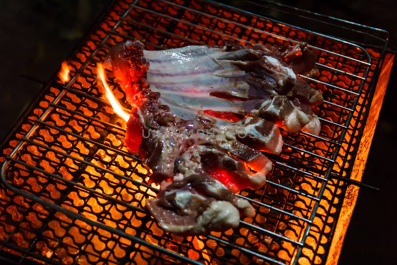 Beef on barbecue stove with flame.